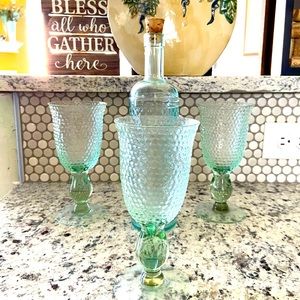 3 glasses with a vase set. Has a vintage feel & look. Very nice wine set.